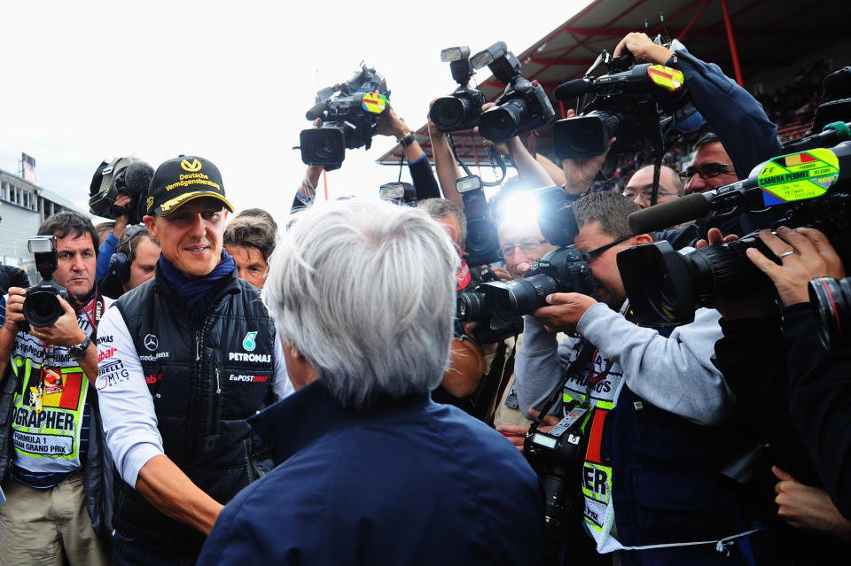 Schumacher and Mercedes GP is congratulated by F1 supremo Bernie Ecclestone (R) as he celebrates the 20th anniversary of his first race before the Belgian Formula One Grand Prix at the Circuit of Spa Francorchamps in 2001. (Getty)