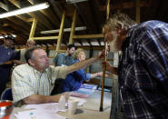 Tim Kaine examines the walking stick of patient Jerry Austin, of Keokee, Va., at the Remote Area Medical Health Clinic in Wise, Va., July 24, 2009. (Photo: Steve Helber/AP)