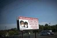 A sign advertises face masks for sale along a major road, Sunday, Oct. 4, 2020, in Jackson, Miss. Across the country, racial minorities, especially Black people, have been hit hard by COVID-19. They are more likely to live in crowded housing and work essential jobs, whether in grocery stores or hospitals, and have a long history of second-rate health care. African Americans have also long struggled with chronic health problems that can cause more deaths from COVID-19. (AP Photo/Wong Maye-E)