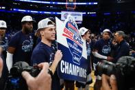 Villanova's Collin Gillespie celebrates with teammates while holding a sign after an NCAA college basketball game against Creighton in the final of the Big East conference tournament Saturday, March 12, 2022, in New York. (AP Photo/Frank Franklin II)
