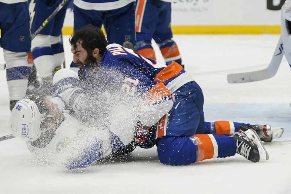 CORRECTS ID TO KYLE PALMIERI (21) NOT OTTO KOIVULA - Tampa Bay Lightning defenseman Mikhail Sergachev (98) and New York Islanders left wing Kyle Palmieri (21) fight during the second period of Game 3 of the NHL hockey Stanley Cup semifinals, Thursday, June 17, 2021, in Uniondale, N.Y. (AP Photo/Frank Franklin II)