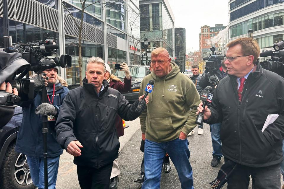 Massachusetts State Police Sgt. Gary Cederquist, center, leaves federal court. Tuesday, Jan 30, 2024, in Boston. Cederquist, 58, of Stoughton,  and five others have been charged Tuesday in a scheme to allegedly take bribes including a new snowblower and driveway in exchange for giving passing scores on commercial driving tests, the U.S. attorney’s office said Tuesday.
 (AP Photo/Michael Casey)