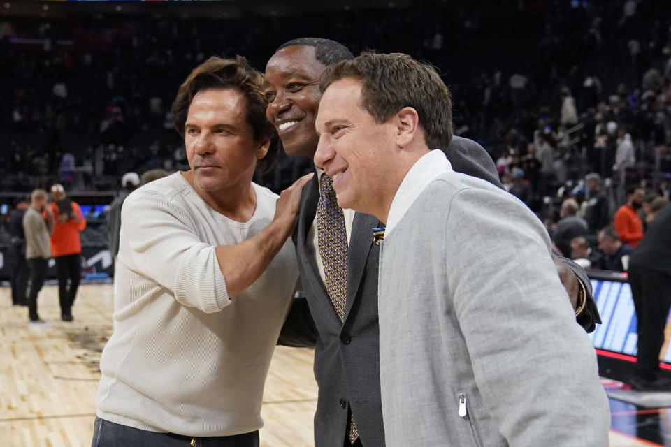 Detroit Pistons owner Tom Gores, left, and Phoenix Suns owner Mat Ishbia pose with former Pistons guard Isiah Thomas after an NBA basketball game between the Detroit Pistons and the Phoenix Suns, Sunday, Nov. 5, 2023, in Detroit. (AP Photo/Carlos Osorio)