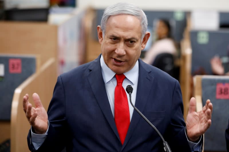 FILE PHOTO: Israeli Prime Minister Benjamin Netanyahu gestures as he delivers a statement during his visit at the Health Ministry national hotline, in Kiryat Malachi, Israel