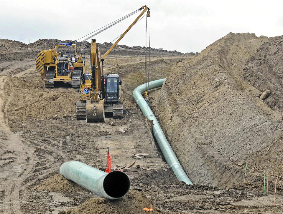 FILE - In this Oct. 5, 2016, file photo, heavy equipment is seen at a site where sections of the Dakota Access pipeline were being buried near the town of St. Anthony in Morton County, N.D. A federal judge on Monday, July 6, 2020, ordered the pipeline to shut down until more environmental review is done. (Tom Stromme/The Bismarck Tribune via AP, File)