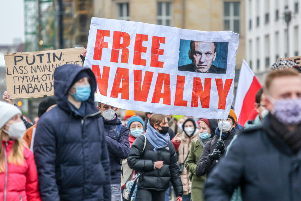 Protesters hold a banner reading "FREE NAVALNY" as some 2,500 supporters of Russian opposition politician Alexei Navalny march in protest to demand his release from prison in Moscow on January 23, 2021 in Berlin, Germany.<span class="copyright">Omer Messinger-Getty Images</span>