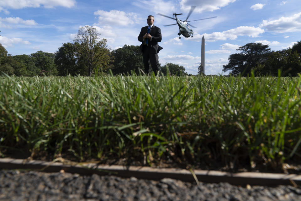 A Secret Service agent stands guard as Marine One with President Joe Biden abroad lifts off from the South Lawn of the White House in Washington, Monday, Sept. 20, 2021, for a short trip to Andrews Air Force Base, Md., and then on to New York ahead of a United Nations General Assembly meeting. (AP Photo/Andrew Harnik)