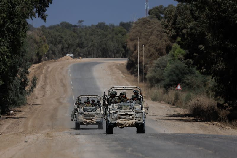 Israeli military vehicles manoeuvre, near the Israel-Gaza border