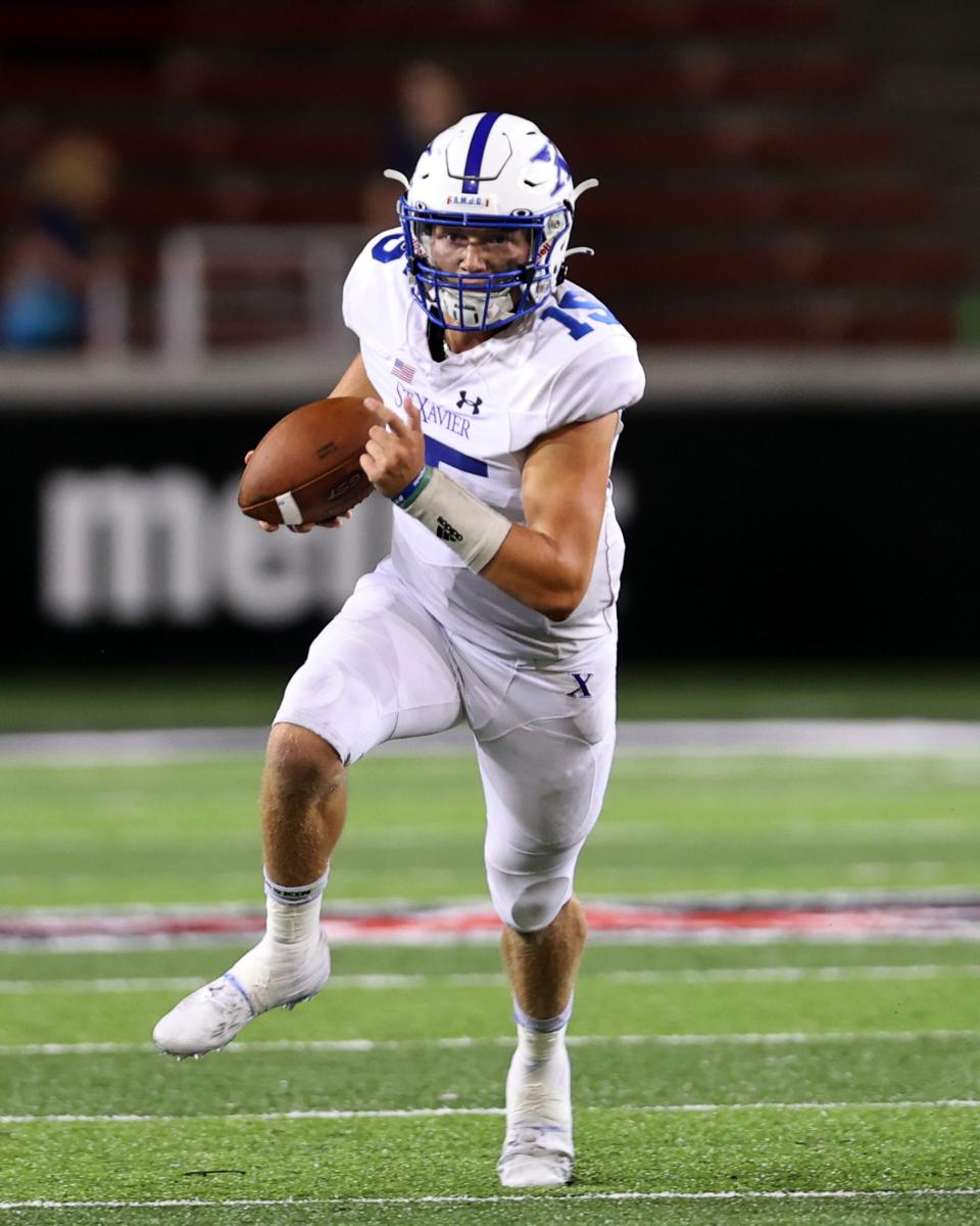 St. Xavier quarterback Brogan McCaughey runs for a big gain in the game between Moeller and St. Xavier high schools at Nippert Stadium, Cincinnati Ohio, Sept 17, 2021.