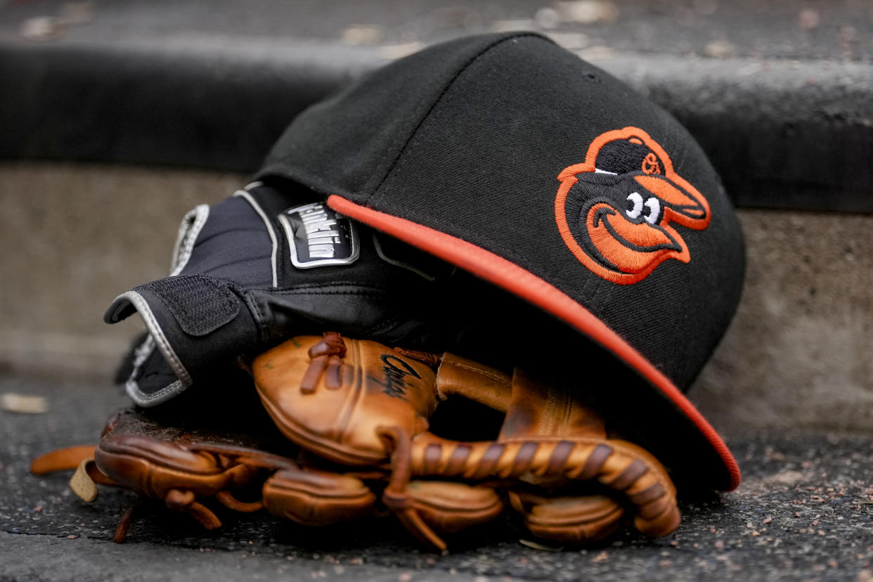 DETROIT, MICHIGAN - MAY 14: A Baltimore Orioles hat is pictured with Franklin batting gloves during the game against the Detroit Tigers at Comerica Park on May 14, 2022 in Detroit, Michigan. (Photo by Nic Antaya/Getty Images)