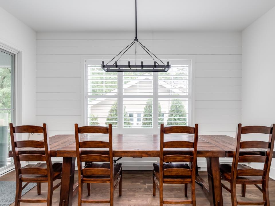 shiplap in dining room with wooden table in the front