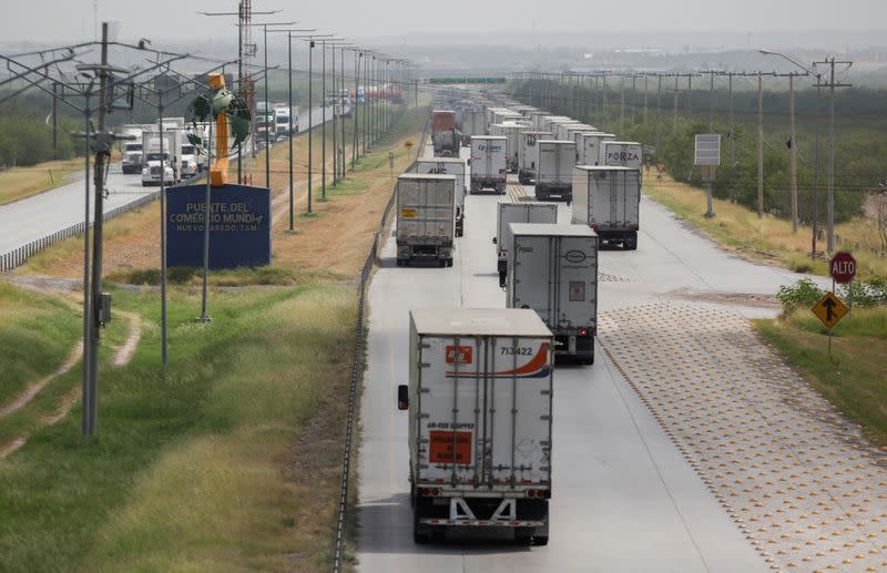 Trucks wait in a long queue for border customs control to cross into the U.S., at the World Trade Bridge in Nuevo Laredo