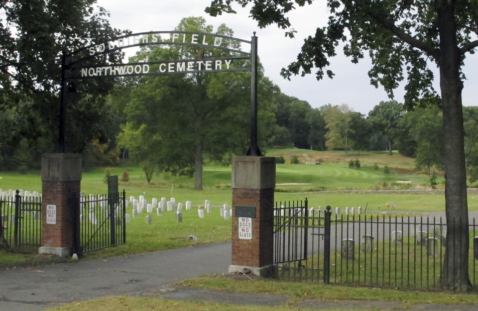 A gate marks the entrance to Northwood Cemetery in Windsor, Conn., on Monday, Oct. 7, 2019, where authorities were exhuming the remains of two unidentified victims of the 1944 Hartford circus fire. Officials will try to determine if one of them is Grace Fifield, of Newport, Vt. Grace Fifield was never seen again after attending the circus. (AP Photo/Dave Collins)