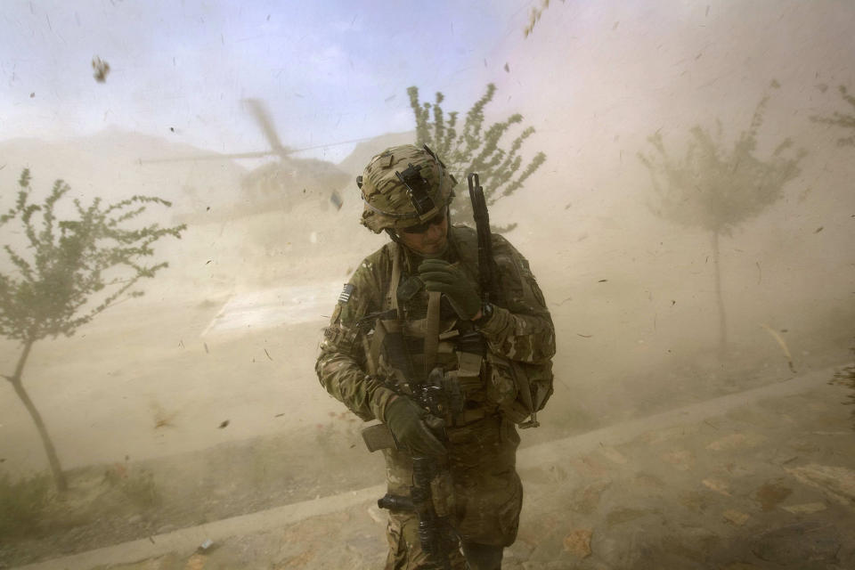 <p>2nd Lt. Andrew Ferrara, 23, of Torrance, Calif., with the U.S. Army’s Bravo Company of the 25th Infantry Division, 3rd Brigade Combat Team, 2nd Battalion 27th Infantry Regiment, based in Schofield Barracks, Hawaii, turns from the rotor wash of a landing Blackhawk helicopter during a mission for a key leader engagement at the Shigal district center, Sept. 15, 2011 in Kunar province, Afghanistan. (AP Photo/David Goldman) </p>