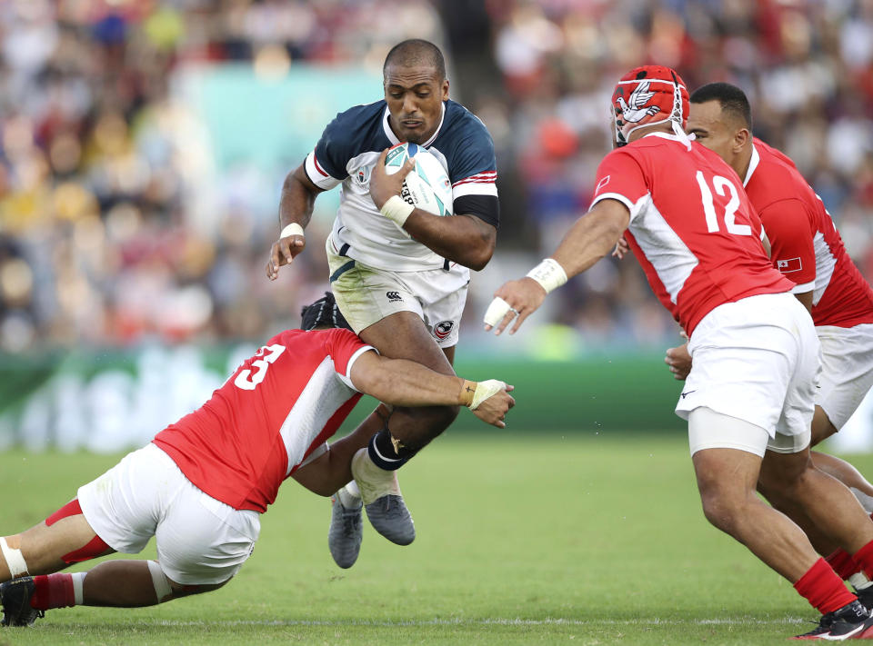 United States' Marcel Brache runs at the Tongan defence during the Rugby World Cup Pool C game at Hanazono Rugby Stadium between USA and Tonga in Osaka, Japan, Sunday, Oct. 13, 2019. Tonga defeated the United States 31-19,(Kyodo News via AP)