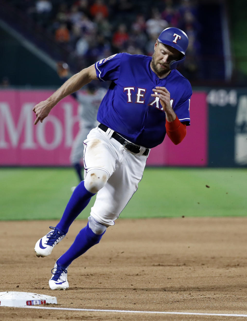 Texas Rangers' Hunter Pence rounds third on his way home to score on a Ronald Guzman double during the fourth inning of the team's baseball game against the Houston Astros in Arlington, Texas, Wednesday, April 3, 2019. (AP Photo/Tony Gutierrez)