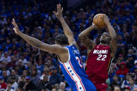 Miami Heat's Jimmy Butler, right, shoots as he is fouled by Philadelphia 76ers' Joel Embiid during the first half of an NBA basketball play-in tournament game Wednesday, April 17, 2024, in Philadelphia. (AP Photo/Chris Szagola)