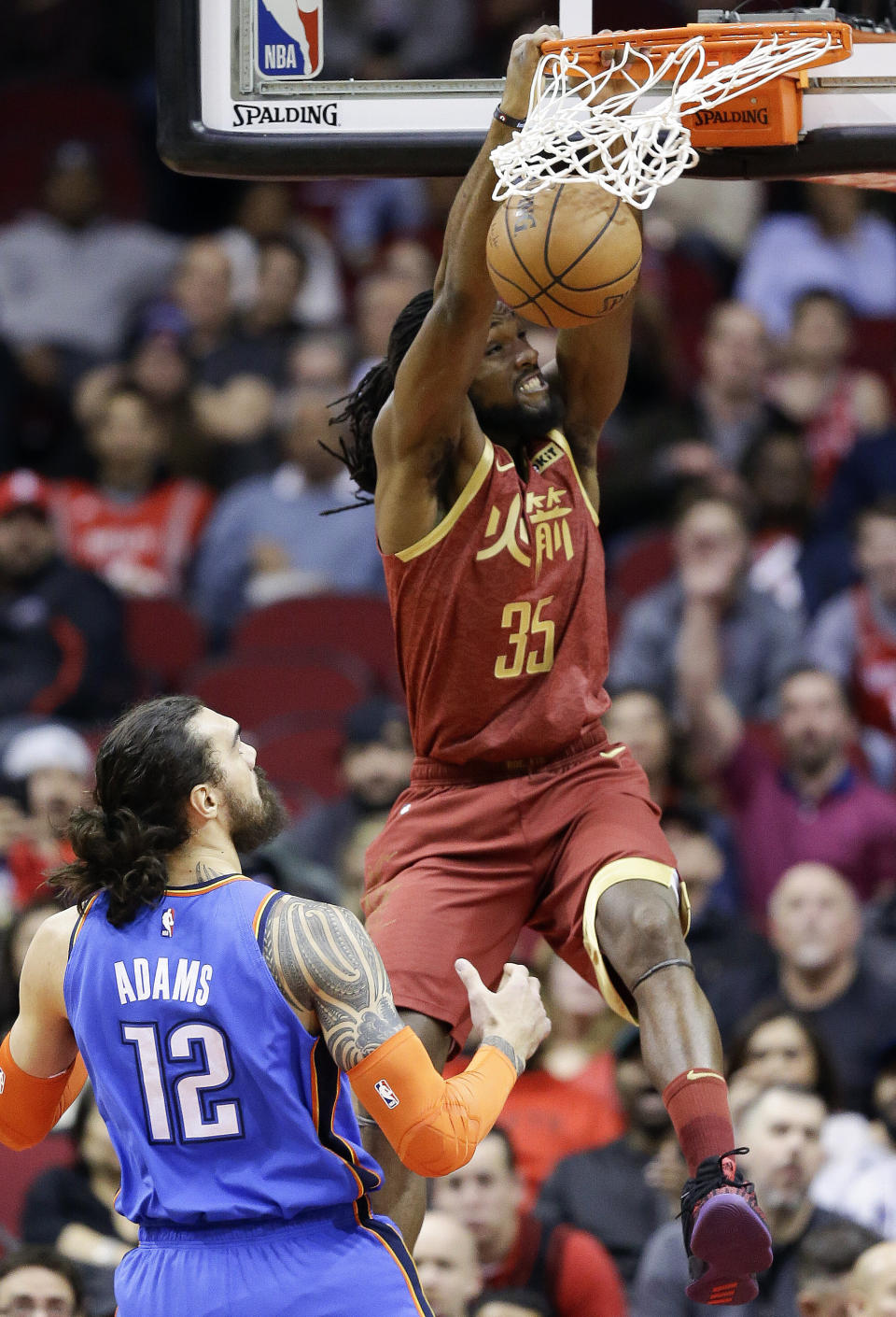 Houston Rockets forward Kenneth Faried (35) dunks as Oklahoma City Thunder center Steven Adams (12) watches during the first half of an NBA basketball game, Saturday, Feb. 9, 2019, in Houston. (AP Photo/Eric Christian Smith)