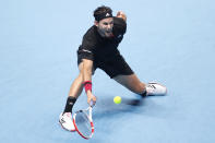 Dominic Thiem of Austria plays a return to Daniil Medvedev of Russia during their singles final tennis match at the ATP World Finals tennis tournament at the O2 arena in London, Sunday, Nov. 22, 2020. (AP Photo/Frank Augstein)