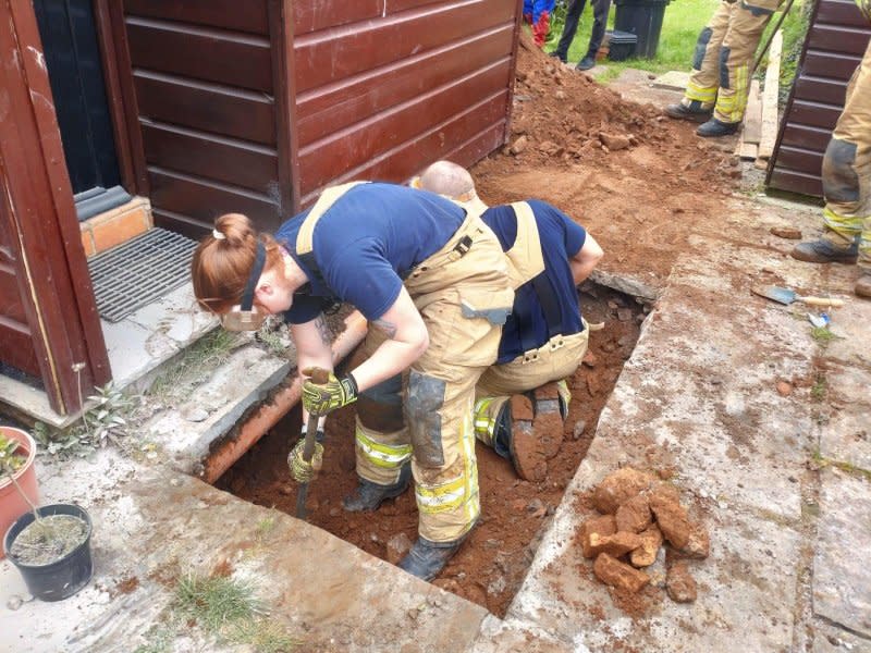 Firefighters in Wales dug a tunnel under a home to rescue a dog stranded beneath the kitchen. Photo courtesy of the Mid and West Wales Fire and Rescue Service
