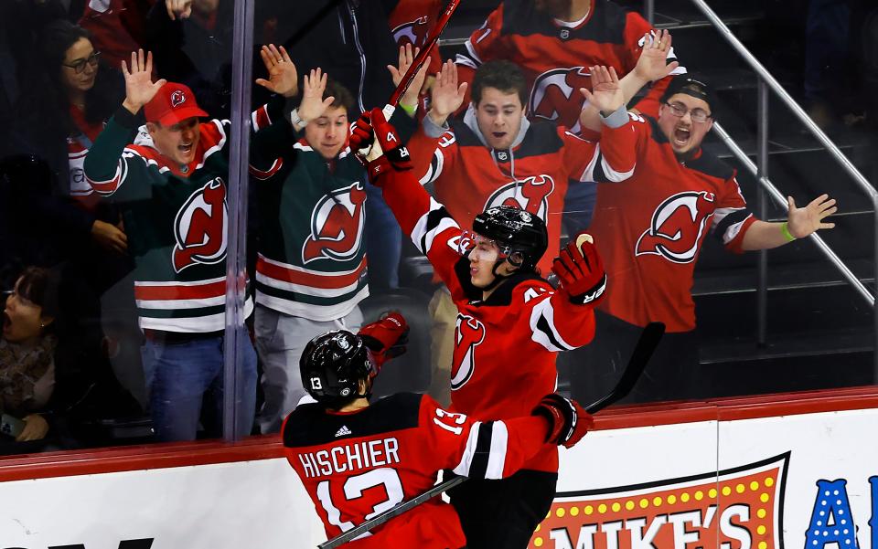 New Jersey Devils defenseman Luke Hughes (43) celebrates after scoring a goal against the Columbus Blue Jackets during the third period of an NHL hockey game Wednesday Dec. 27, 2023, in Newark, N.J. The New Jersey Devils won 4-3 in overtime. (AP Photo/Noah K. Murray)