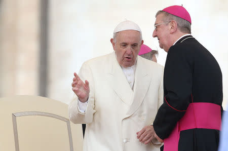 Pope Francis speaks with Archbishop of Dublin Diarmuid Martin before the Wednesday general audience in Saint Peter's square at the Vatican, March 21, 2018. REUTERS/Tony Gentile