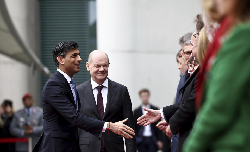 German Chancellor Olaf Scholz, second left, and Britain's Prime Minister Rishi Sunak, left, greet delegation members during an official welcome ceremony at the Chancellery in Berlin, Wednesday April 24, 2024. (Henry Nicholls/Pool via AP)