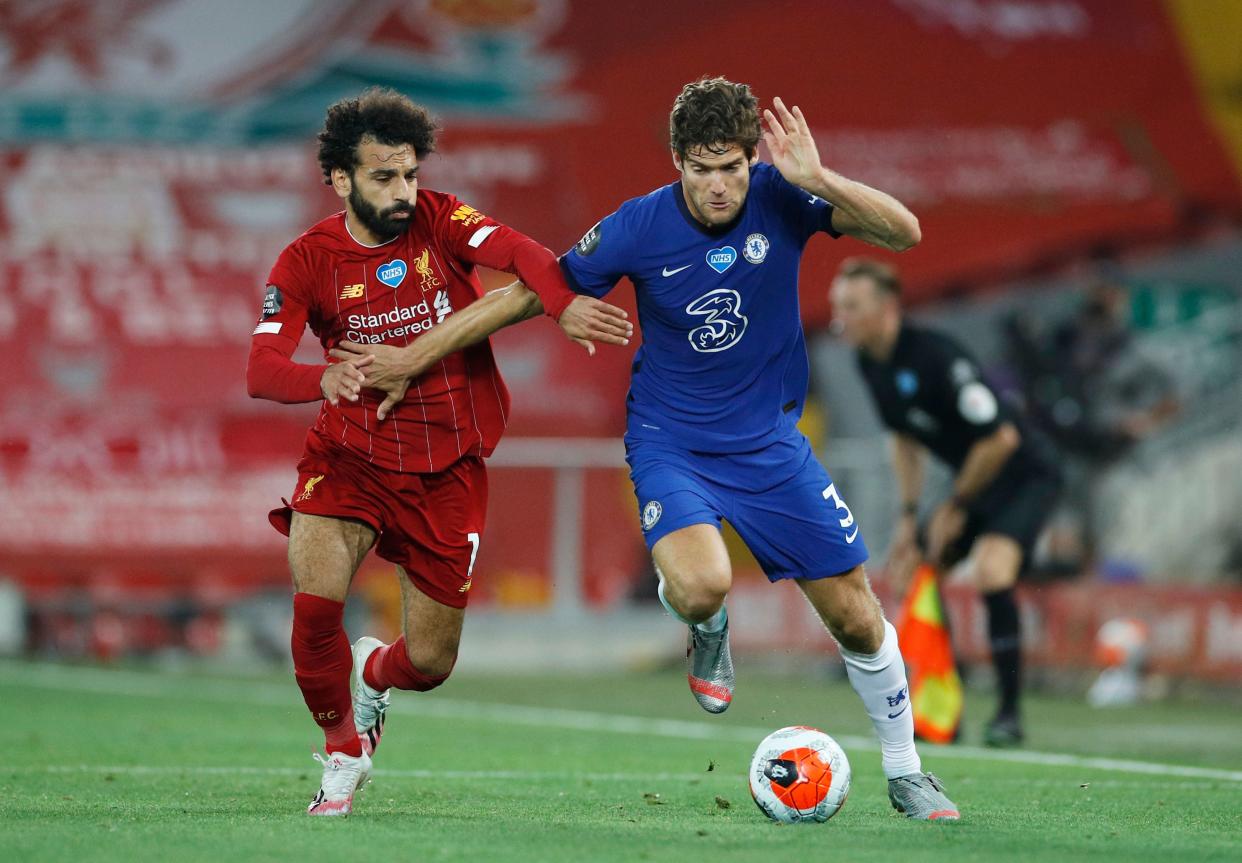 Soccer Football - Premier League - Liverpool v Chelsea - Anfield, Liverpool, Britain - July 22, 2020 Liverpool's Mohamed Salah in action with Chelsea's Marcos Alonso, as play resumes behind closed doors following the outbreak of the coronavirus disease (COVID-19) Pool via REUTERS/Phil Noble EDITORIAL USE ONLY. No use with unauthorized audio, video, data, fixture lists, club/league logos or 'live' services. Online in-match use limited to 75 images, no video emulation. No use in betting, games or single club/league/player publications.  Please contact your account representative for further details.