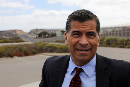 California Attorney General Xavier Becerra walks along the U.S. Mexico border after announcing a lawsuit against the Trump Administration over its plan to begin construction of border wall projects in San Diego and Imperial Counties in San Diego, California, U.S. September 20, 2017. REUTERS/Mike Blake