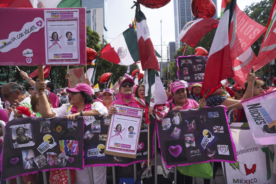 FILE - Supporters of opposition presidential candidate Xóchitl Gálvez attend a campaign event at the Angel of Independence monument, in Mexico City, Sept. 3, 2023. Mexican voters will go to the polls in the largest elections in the country’s history on June 2, 2024. In the presidential race, they will have to choose between three candidates, but two women have taken the lead: Gálvez and ruling party candidate Claudia Sheinbaum. (AP Photo/Marco Ugarte, File)