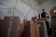 An employee prepares an order for Amazon at Porona warehouse in Bruay-sur-l'Escaut
