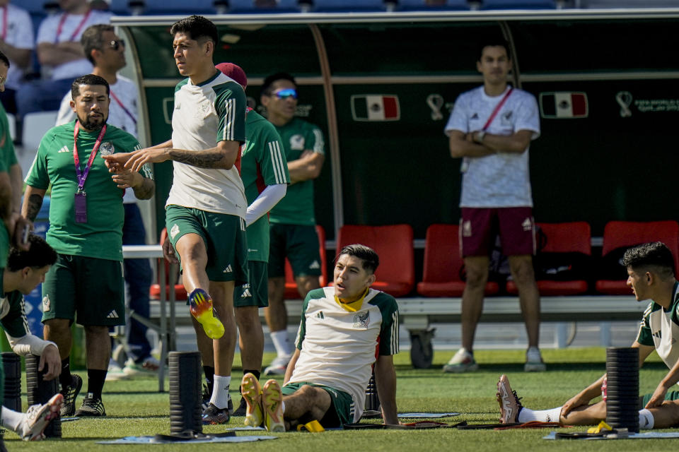 Edson Alvarez, left, stretches during Mexico official training on the eve of the group C World Cup soccer match between Saudi Arabia and Mexico, in Jor , Qatar, Tuesday, Nov. 29, 2022. (AP Photo/Moises Castillo)