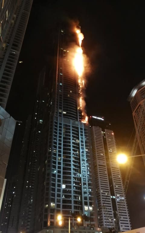 Flames shoot up the sides of the Torch tower residential building in the Marina district, Dubai - Credit: Reuters