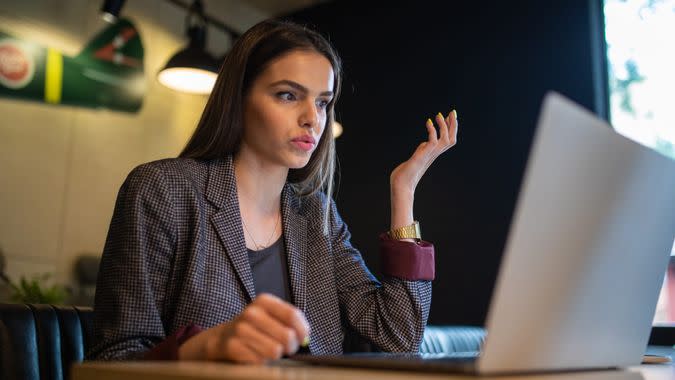 Businesswoman doing her tiresome work while sitting in her local cafe.