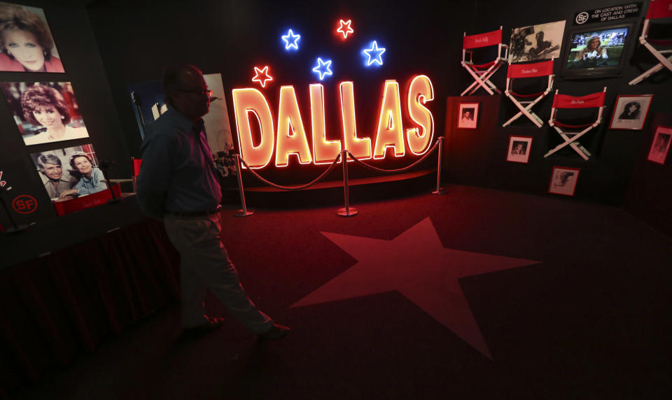 In this photo made Tuesday, Nov. 13, 2012, a tourist looks at the Dallas TV show museum at Southfork Ranch in Parker, Texas. Tourists have been flocking to Southfork Ranch since the early years of the classic series, which ran from 1978 to 1991. And a new “Dallas” starting its second season on TNT on Monday and the recent death of the show's star, Larry Hagman, who legendarily played conniving Texas oilman J.R. Ewing, have also spurred fans to visit. (AP Photo/LM Otero)