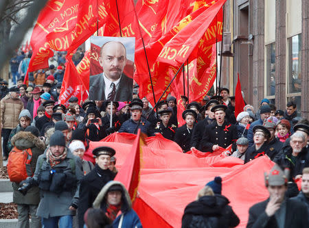 Demonstrators carry a giant Soviet flag during a rally held by Russian Communist party to mark the Red October revolution's centenary in central Moscow, Russia November 7, 2017. REUTERS/Sergei Karpukhin
