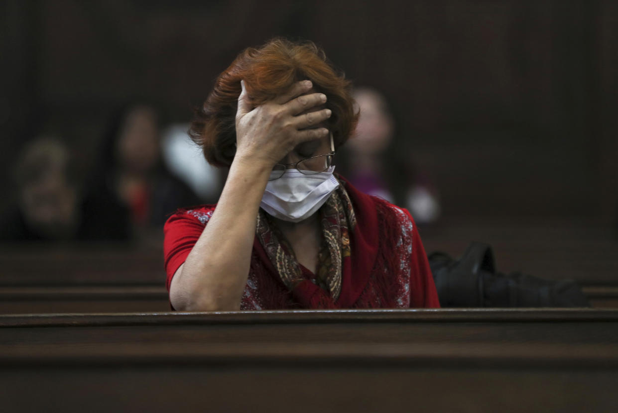 A woman wears a surgical mask as a precaution against the spread of the new coronavirus COVID-19 during a Mass commemorating Ash Wednesday at the Cathedral in Mexico City, Wednesday, Feb. 26, 2020. Ash Wednesday marks the beginning of Lent, a solemn period of 40 days of prayer and self-denial leading up to Easter. (AP Photo/Fernando Llano)