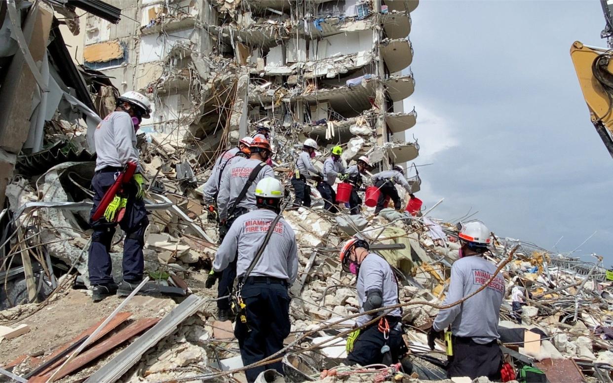 Rescue crew at the site after a partial building collapse in Surfside near Miami Beach - via Reuters