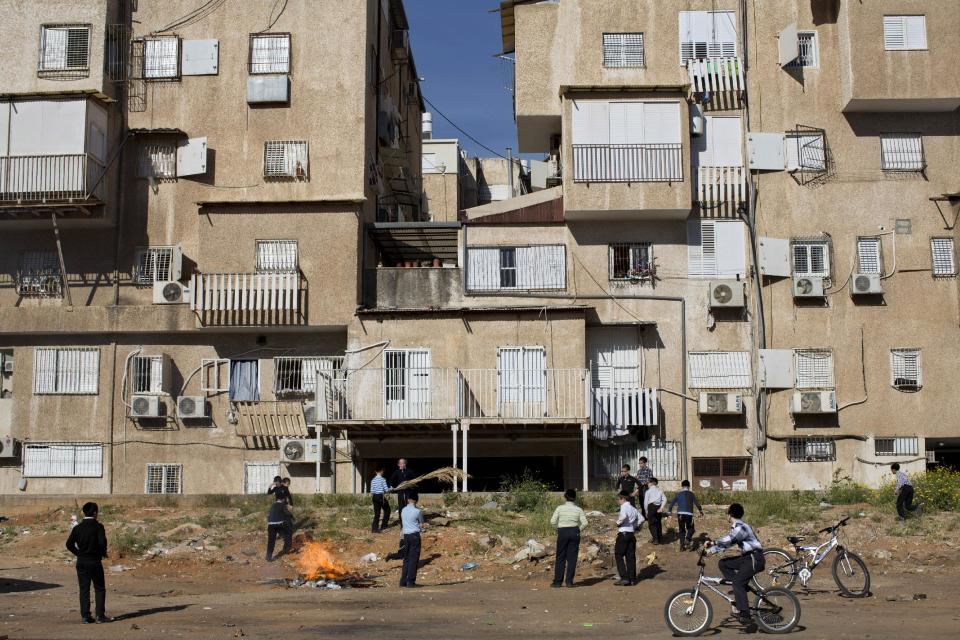 Ultra-Orthodox Jewish youth burn leavened items in final preparation for the Passover holiday in the ultra-Orthodox Jewish town of Bnei Brak, near Tel Aviv, Israel, Monday, April 14, 2014. Jews are forbidden to eat leavened foodstuffs during the Passover holiday that celebrates the biblical story of the Israelites' escape from slavery and exodus from Egypt. (AP Photo/Oded Balilty)