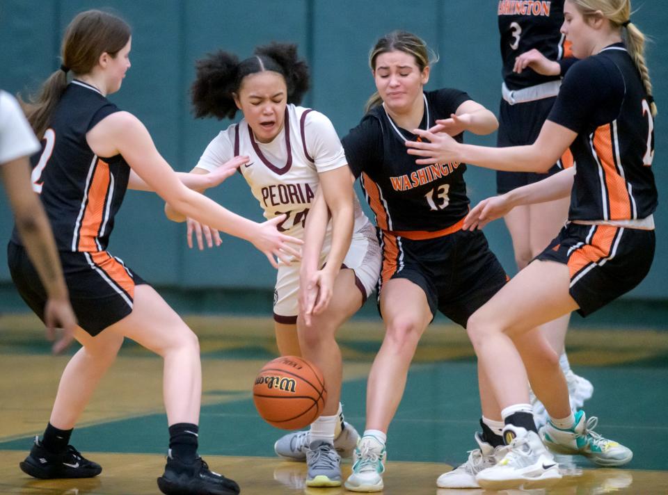 Peoria High's Allannah Jackson (24) struggles for possession with Washington's Addie Kimler (13), Avery Tibbs, left, and Emma Heidebreder in the first half of the Class 3A Girls Basketball Richwoods Sectional title game Thursday, Feb. 23, 2023 at Richwoods High School. The Lions advanced to the Pontiac supersectional with a 35-29 win over the Panthers.