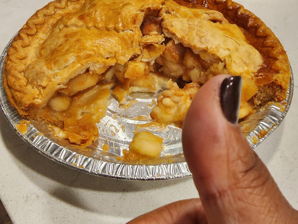 The writer holds a thumbs up in front of apple pie from H-E-B