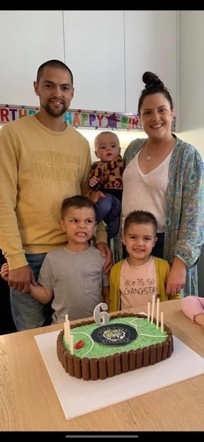 Michael Holmes and his family pictured around a birthday cake. The family were inside the Tyaak holiday home in Victoria when it caught on fire.