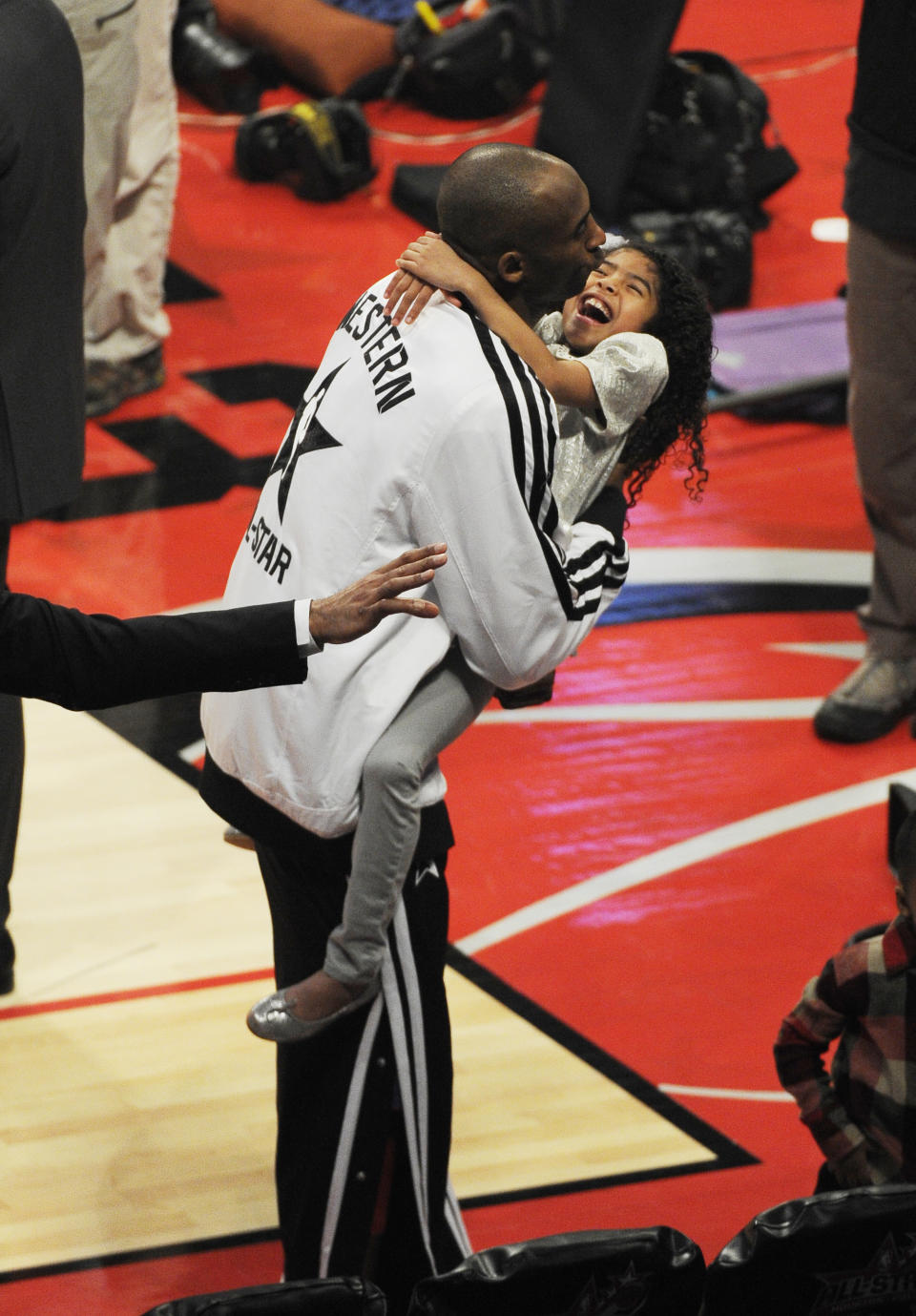 Kobe Bryant hugs his daughter Gianna Maria-Onore Bryant during halftime of the NBA All-Star basketball game Sunday, Feb. 17, 2013, in Houston. (AP Photo/Pat Sullivan)