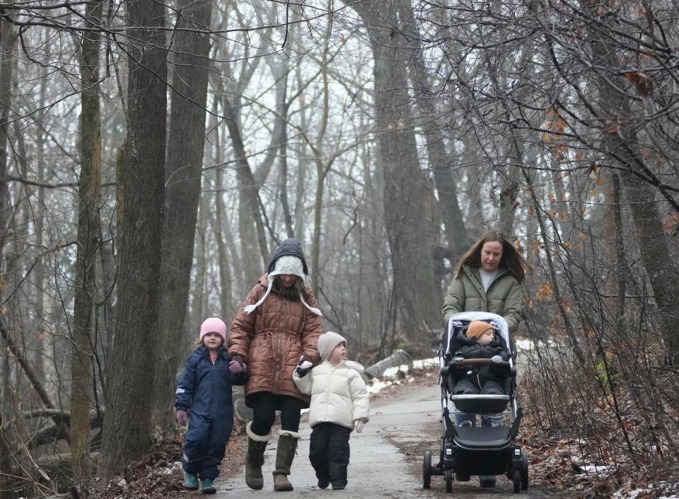 Pam Stumpf (left), of Mequon, and her daughter, Kila Larson, of Cedarburg, brave the mist and chilly temperatures during a walk with (from left) Larson’s niece, Sage Bennett, 4, of Fox Point, and Larson’s two children, Noa, 3, and Milo, 1, at the Schlitz Audubon Nature Center in Bayside on Friday, Jan. 26, 2024.