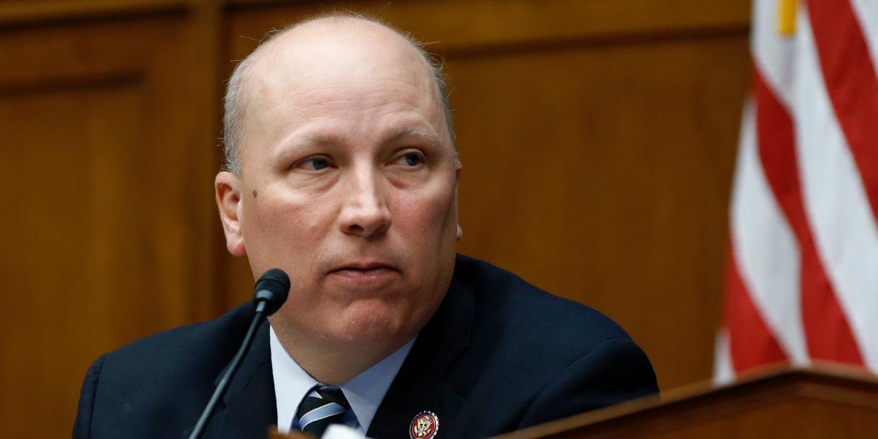 Rep. Chip Roy sitting next to a microphone at a congressional hearing, with part of a US flag visible in the background.