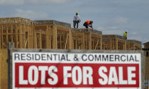 A construction crew works on a new project, Friday, Sept. 17, 2021, in McAllen, Texas. Between 1990 and 2020, McAllen and the neighboring cities of Edinburg and Mission grew sixfold to nearly 871,000 people, according to the U.S. Census Bureau. (AP Photo/Eric Gay)