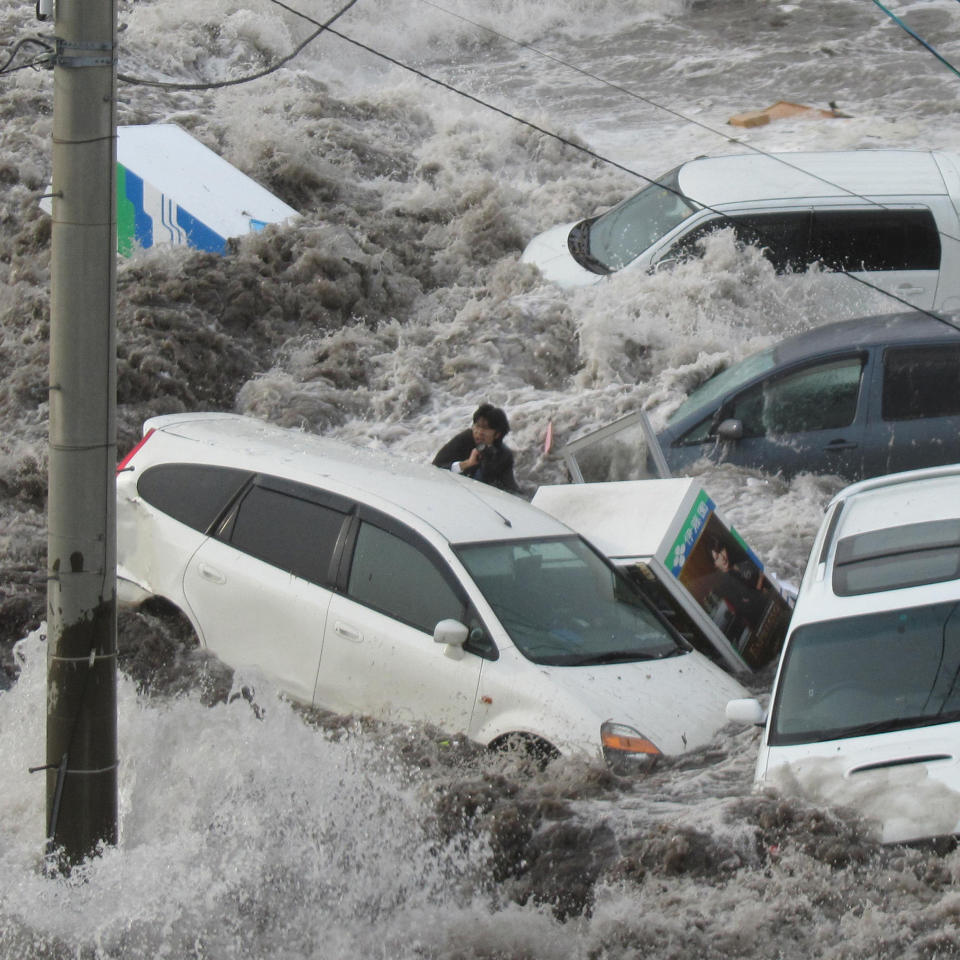 Toya Chiba, a reporter for local newspaper Iwate Tokai Shimbun, is swept by a tsunami at Kamaishi port