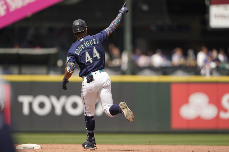 Seattle Mariners' Julio Rodriguez gestures as he runs the bases on a three-run home run against the Texas Rangers during the seventh inning of a baseball game Wednesday, July 27, 2022, in Seattle. (AP Photo/Ted S. Warren)