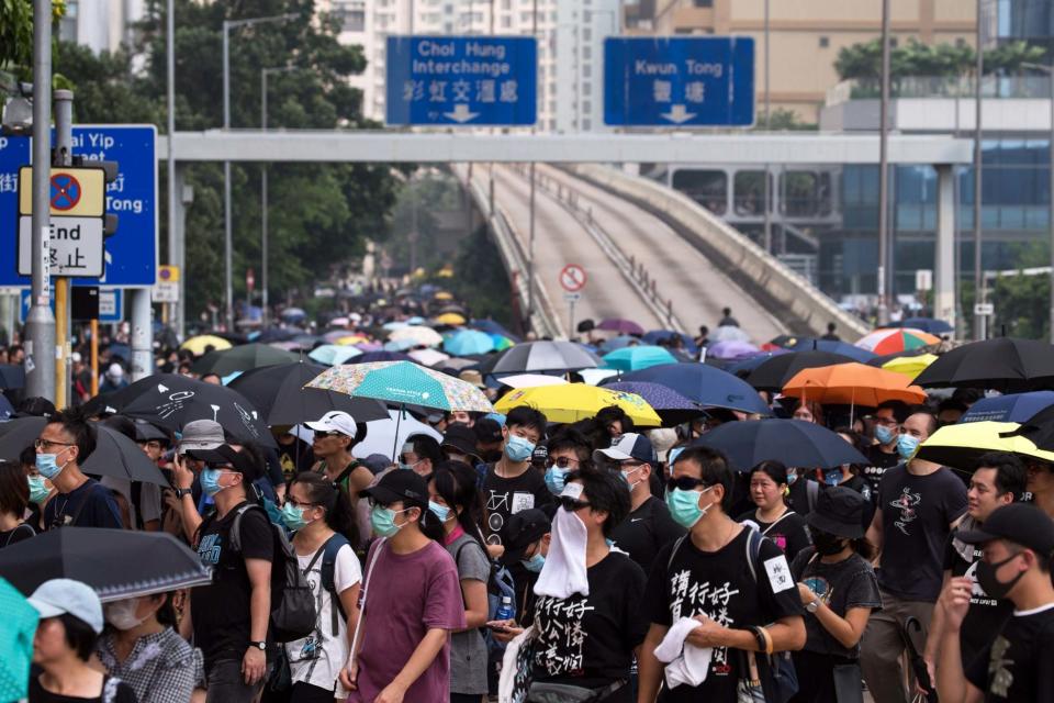 Protesters take part in an anti-government march in Kwun Tong (EPA)