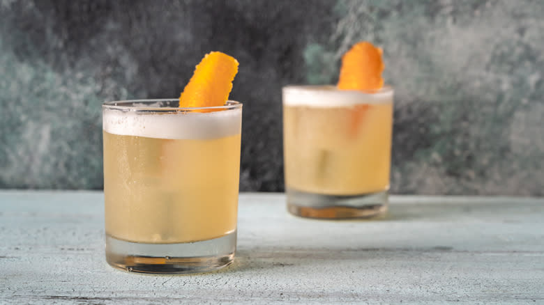 Whisky sour cocktail with orange peel
